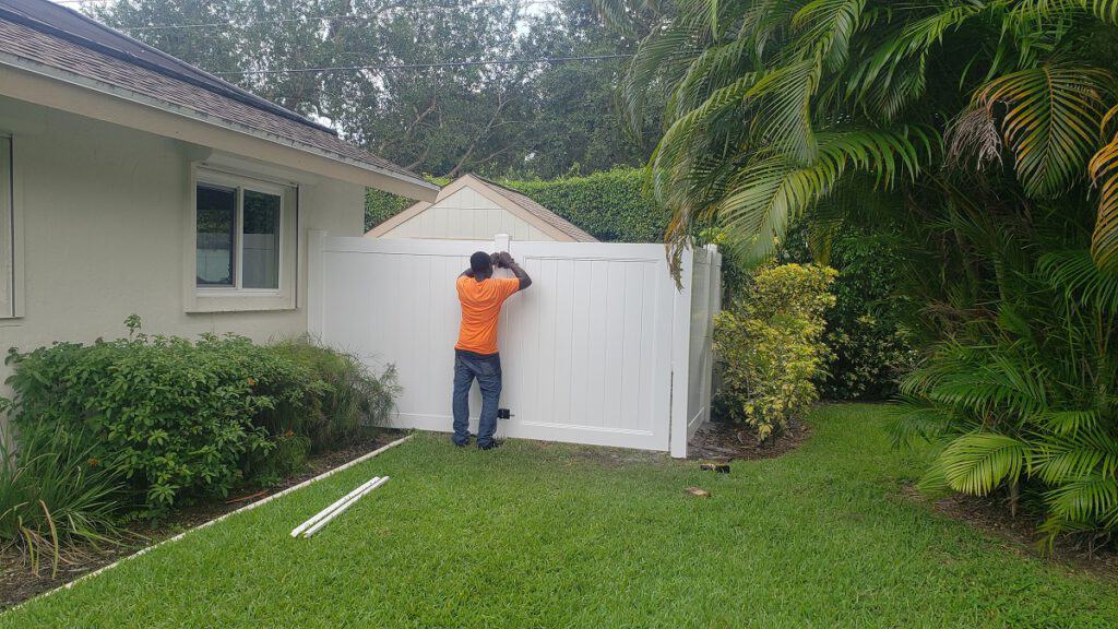 Fence Builders of Dallas repairing a white vinyl fence